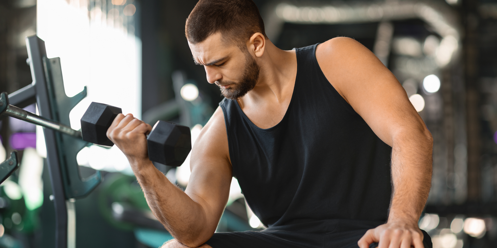 Man doing seated dumbbell curls